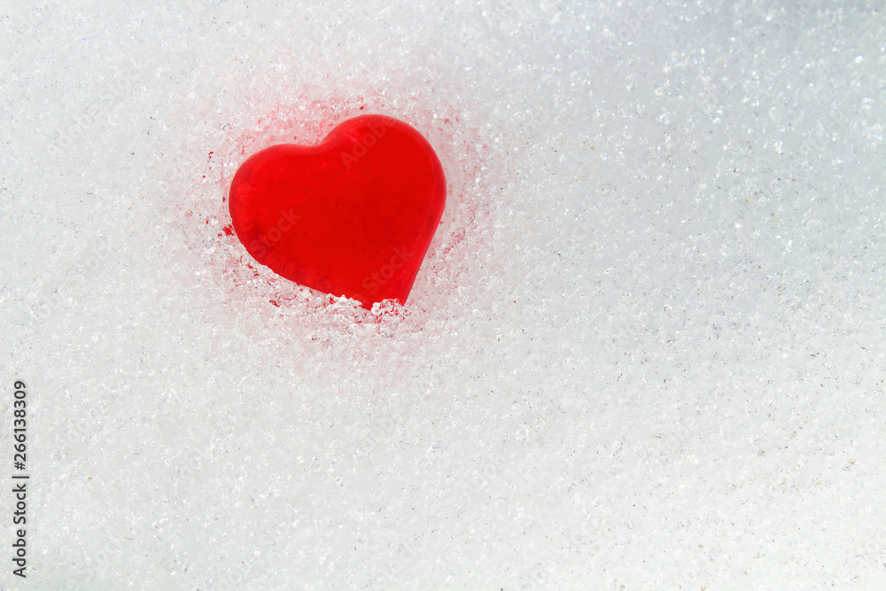 Fototapeta premium Red heart in the snow. Close-up. Background. Texture.