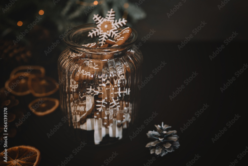 Christmas gift with homemade gingerbread cookies, nuts and chocolates. Glass jar, fir branches, Christmas spices and decor. Winter holidays, New Year or Christmas concept. Top view with copy space. Christmas gift with homemade gingerbread cookies, nuts and chocolates. Glass jar, fir branches, Christmas spices and decor. Winter holidays, New Year or Christmas concept. Top view with copy space.