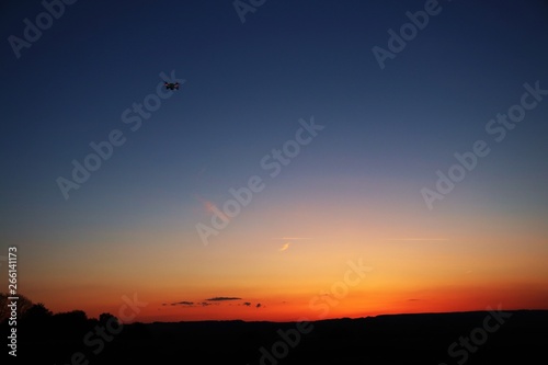 Drone flying into sunset