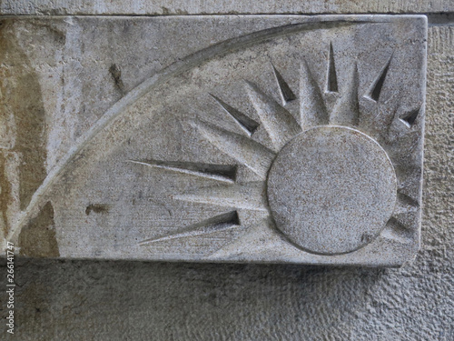 image of the sun cut out in freestone on a facade of a house in Amsterdam