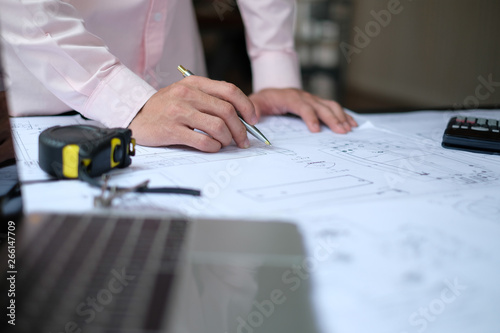 architect engineer working on house blueprint of real estate project at workplace. construction & building concept
