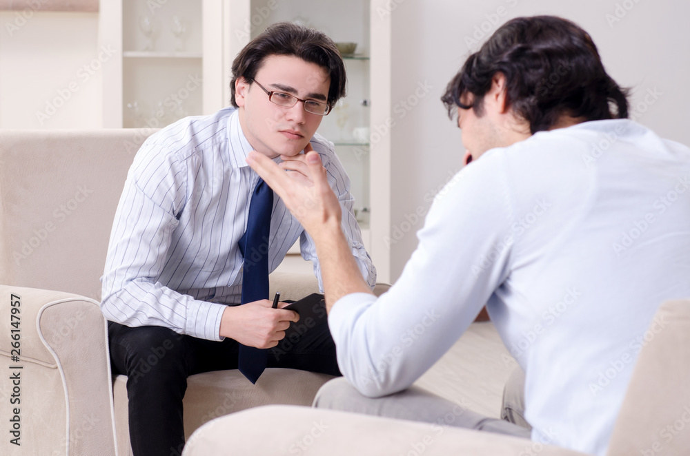 Young male patient discussing with psychologist personal problem Young male patient discussing with psychologist personal problem