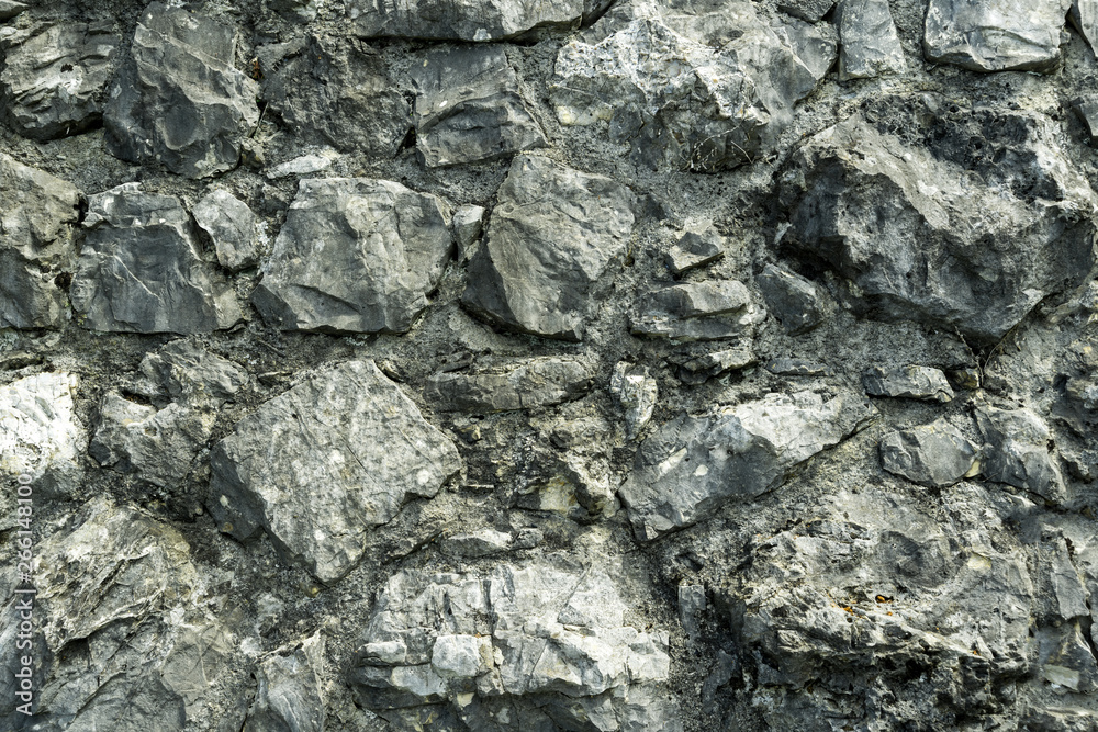 Fototapeta premium The texture of the wall of the cobblestones.