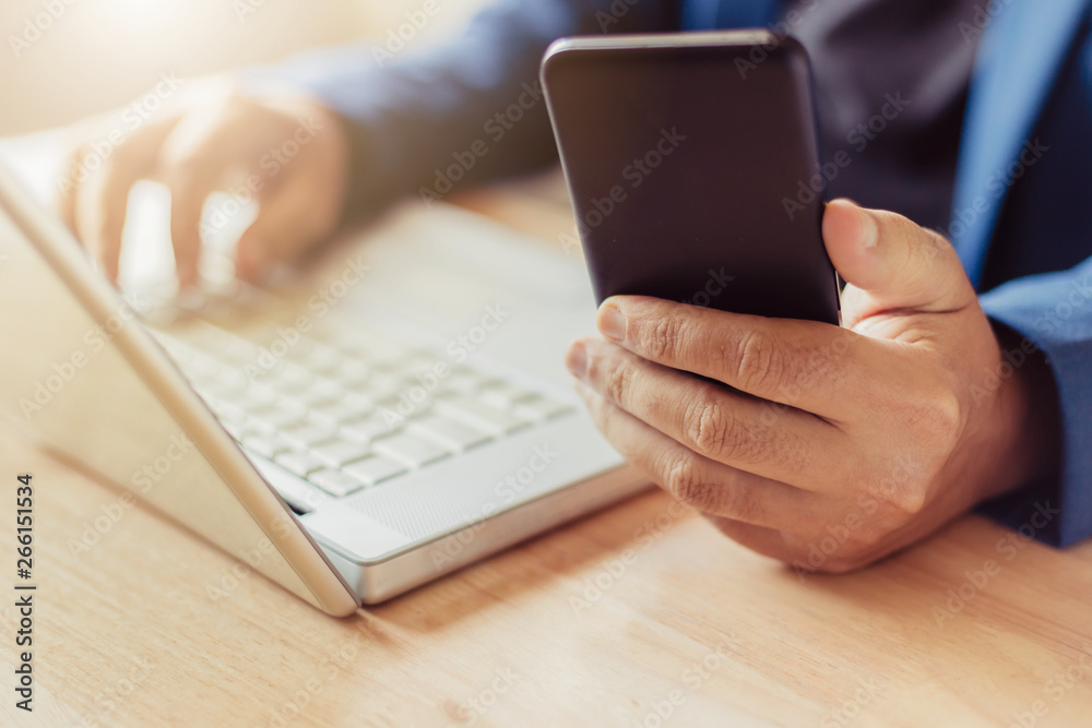 businessman use laptop and smartphone for work hard.