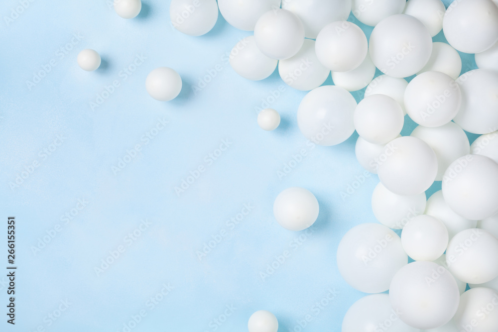 Pastel blue table with white balloons top view. Party or birthday background. Flat lay style. Pastel blue table with white balloons top view. Party or birthday background. Flat lay style.