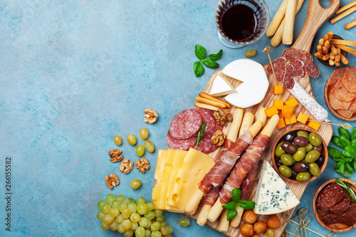 Obraz na plátně Italian appetizers or antipasto set with gourmet food on blue table top view