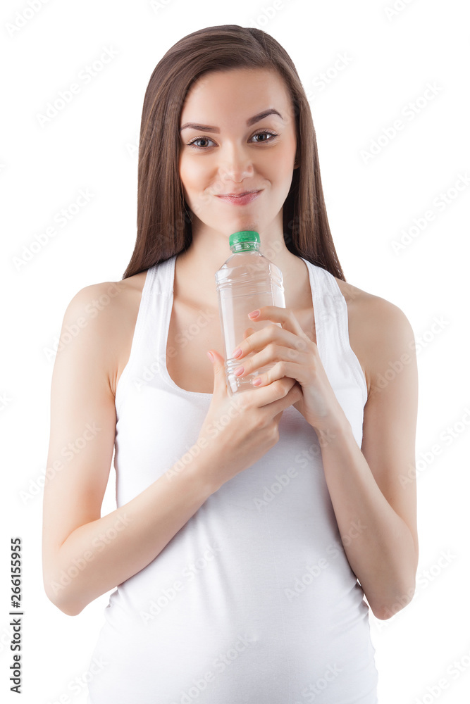 Attractive young woman drinking water on isolated white background. Female holding bottle of water. Attractive young woman drinking water on isolated white background. Female holding bottle of water.