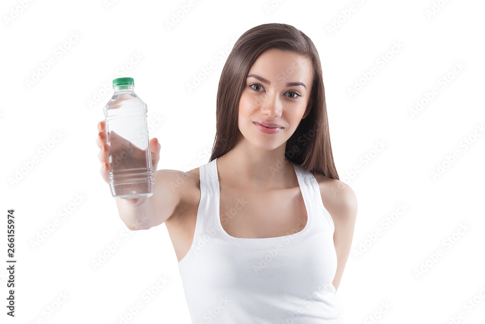 Attractive young woman drinking water on isolated white background. Female holding bottle of water. Attractive young woman drinking water on isolated white background. Female holding bottle of water.