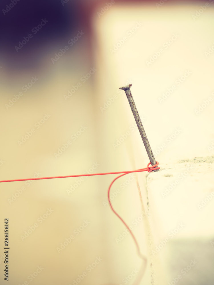 String net placed on spike nail String net placed on spike nail