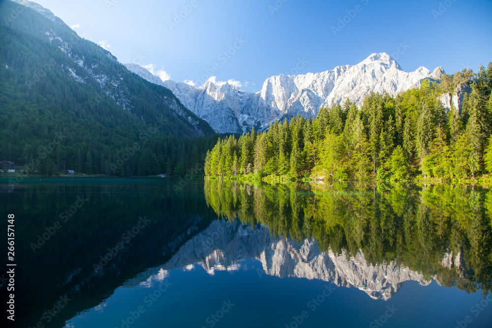 Beautiful morning scene with alpine peaks reflecting in tranquil mountain lake - obrazy, fototapety, plakaty 