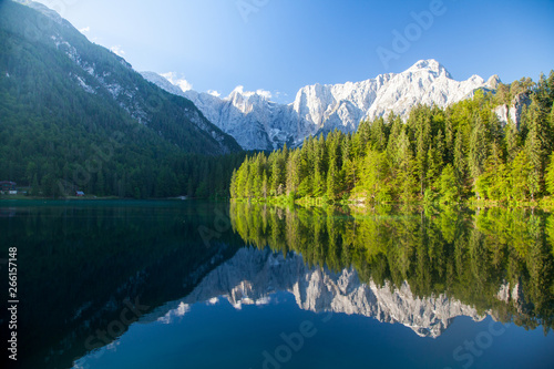 Beautiful morning scene with alpine peaks reflecting in tranquil mountain lake