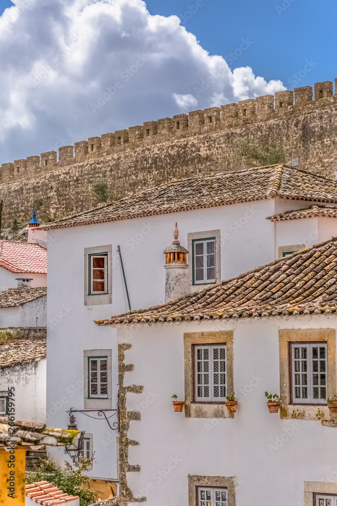 View of the fortress and Luso Roman castle of Óbidos, with buildings of Portuguese vernacular architecture and s