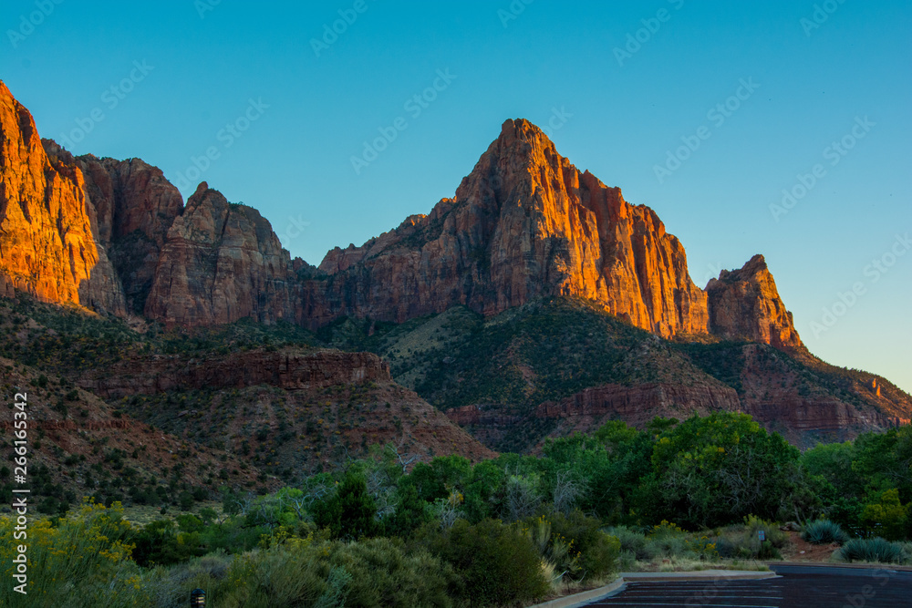 Red Sunset in Zion National Park green and orange colours with blue sky