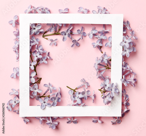 Creative layout made of lilac spring flowers on a pink background. Minimal holiday concept. Flat lay pattern.