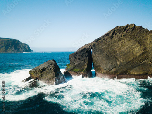 Birds eye view picture about wild rock formations in the middle of the open atlantic ocean next to Mosteiros, in Sao Miguel island, Azores, Portugal