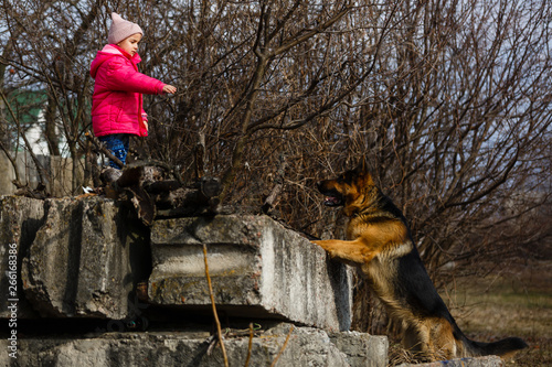Little girl standing with dog on street,Danger,Blurry,Selective focus