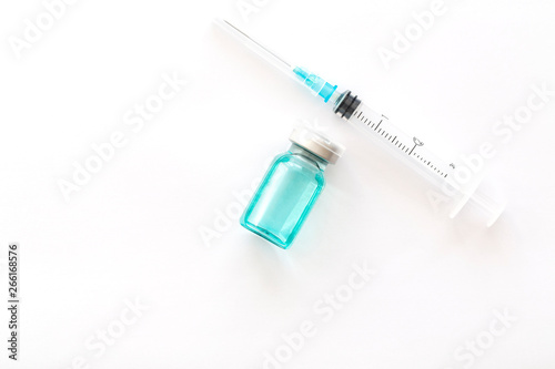 Concept of injection cosmetology. Syringe and glass Medicine Vial with preparation for mesotherapy on white background. Selective focus. Copy space