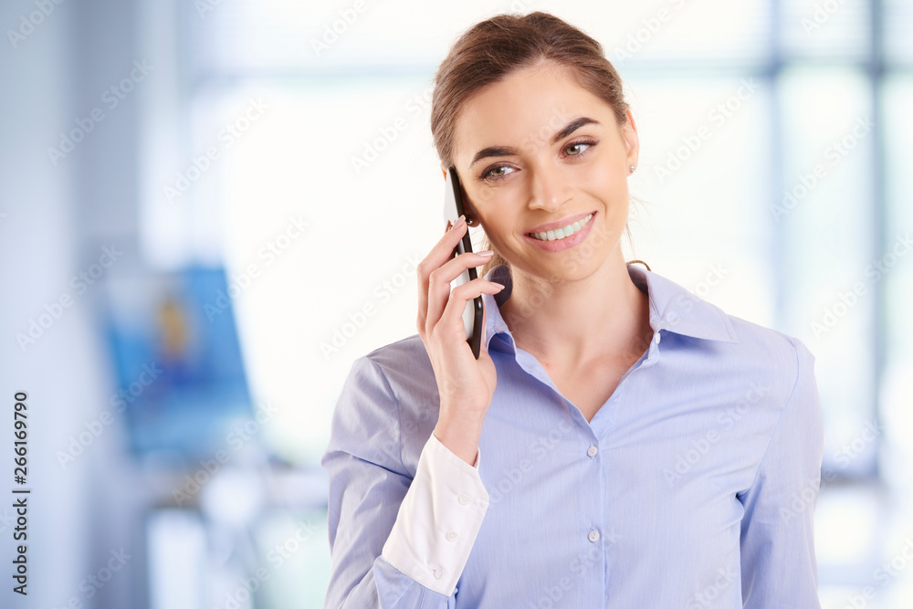 Portrait of young businesswoman making a phone call on her cell phone Portrait of young businesswoman making a phone call on her cell phone