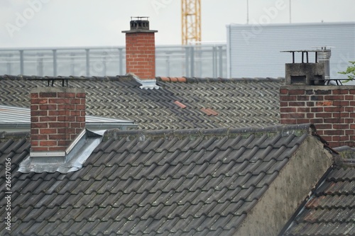 old rooftop with brick chimneys
