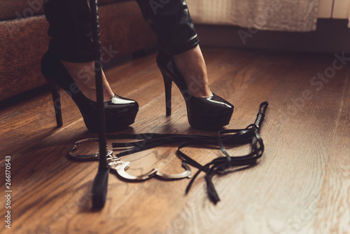 woman black high heels and sex toys. Sexy woman fetish pumps and whip, bdsm  concept Stock Photo | Adobe Stock