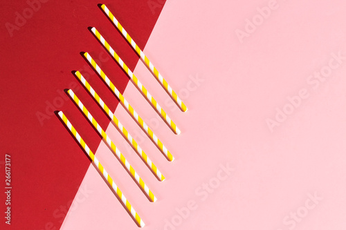 a pile of strired paper straws for cocktail, copy space. flat view, montessory education photo