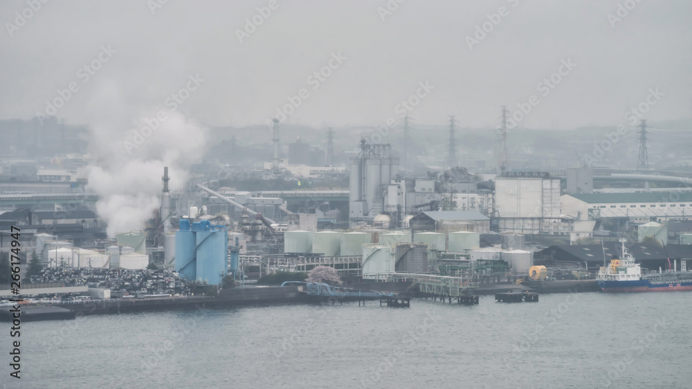 factory pipes with smoke near port