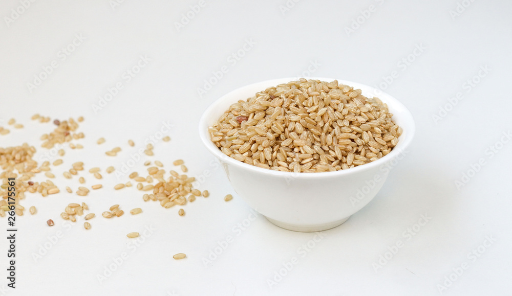 Bowl of long grain brown rice isolated on white background Bowl of long grain brown rice isolated on white background
