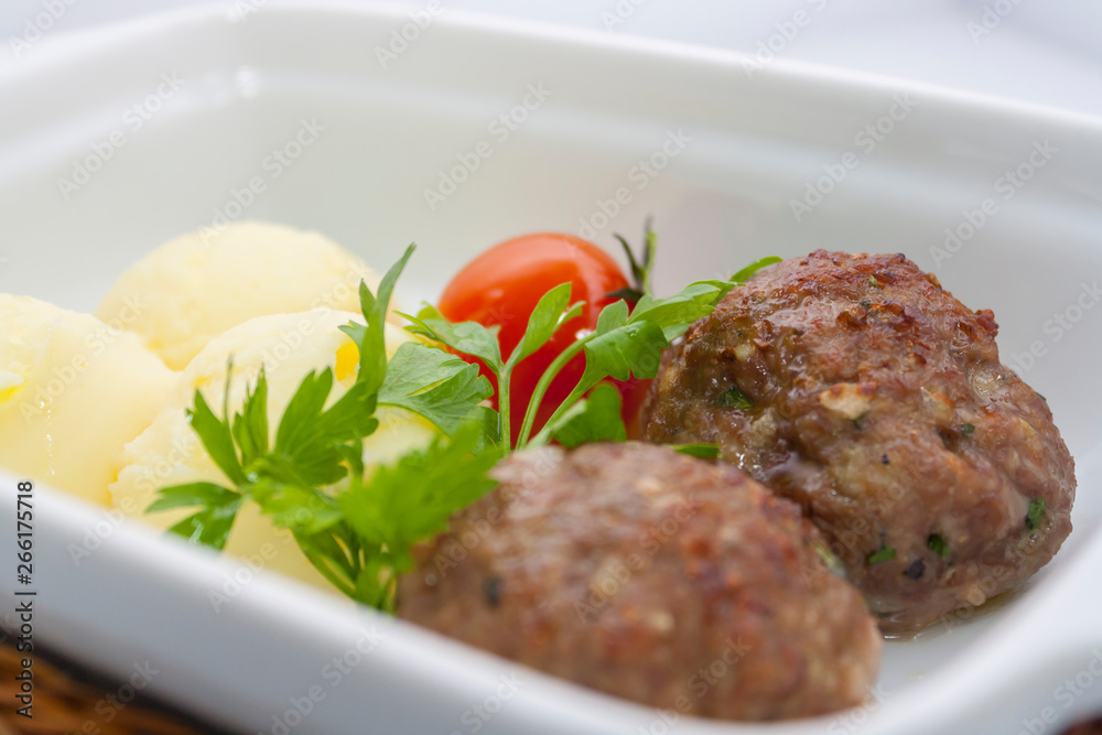 beef meat balls with mashed potatoes and pickled tomatoes in a wicker basket beef meat balls with mashed potatoes and pickled tomatoes in a wicker basket