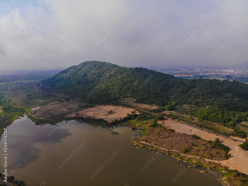 Top view of plantation, mountain lake, misty sky in Thailand.