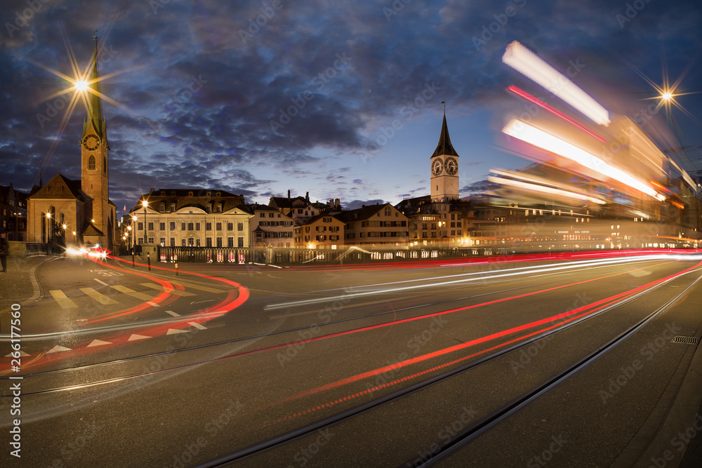 Traffic at night - Zurich skyline with tram and cars going by - long exposure