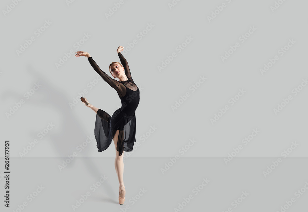 Female ballet dancer dancer over gray background. Female ballet dancer dancer over gray background.