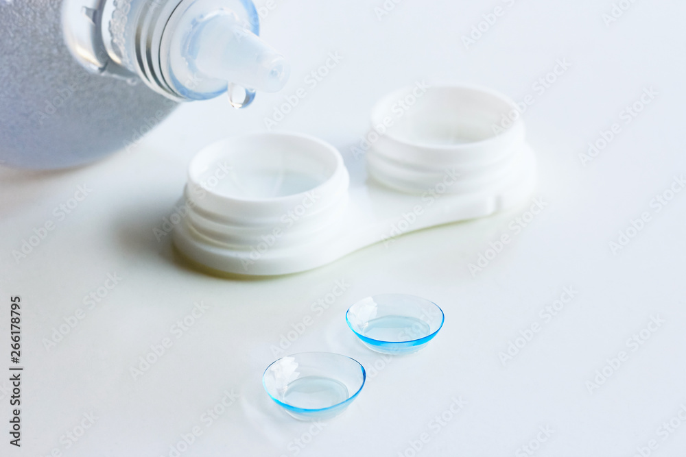 Contact lenses, case and bottle with solution on white background. Eye health and care, eyesight and vision, ophthalmology and optometry Contact lenses, case and bottle with solution on white background. Eye health and care, eyesight and vision, ophthalmology and optometry