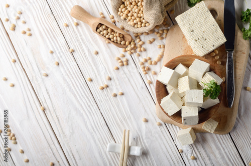 Photos Soy Bean curd tofu in wooden bowl and in hemp sack on white wooden kitchen table