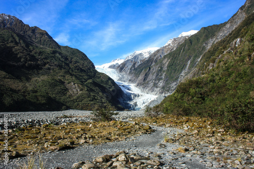 View on the Franz Josef Glacier  rocky climb with some green vegetation on both sides  West Coast of New Zealand s South Island