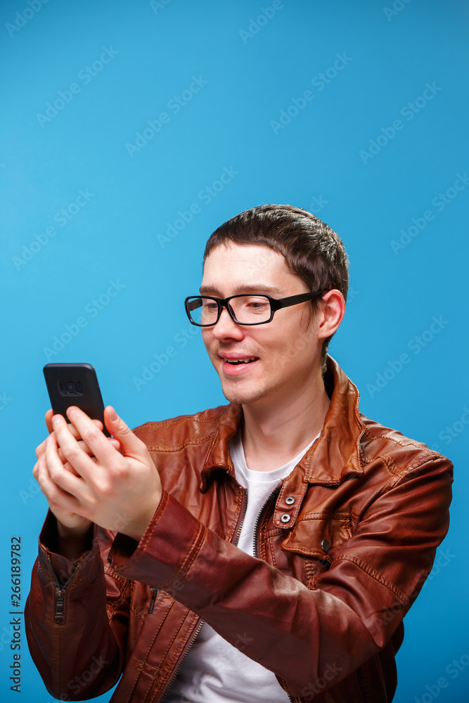 A man uses the phone and looks at the screen.