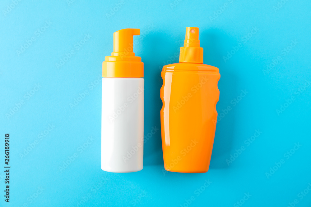 Composition with sunscreen sprays on color background. Space for text, top view Composition with sunscreen sprays on color background. Space for text, top view
