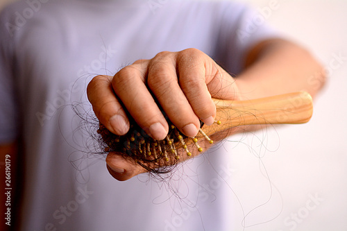 Hair loss, hair fall everyday serious problem, girl with a comb and problem hair on white background.