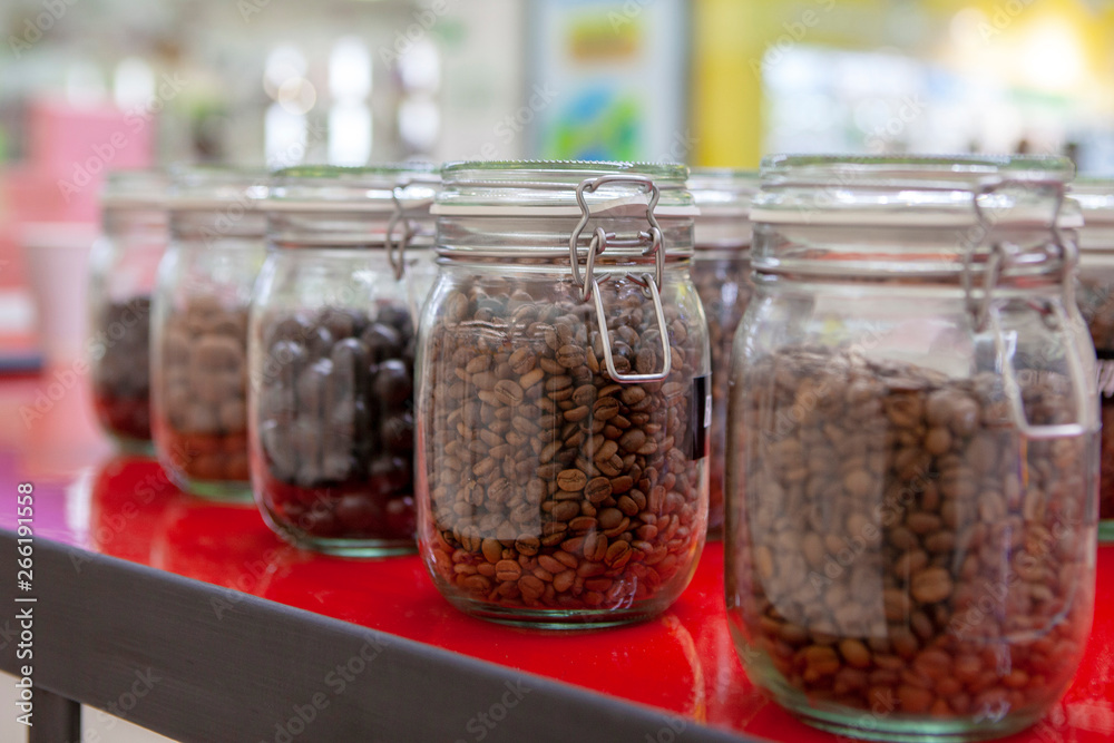 Coffee beans in glass jars on the cafe counter. Coffee beans in glass jars on the cafe counter.