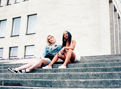 Two teenage girls infront of university building smiling, having fun traveling europe, lifestyle people concept close up
