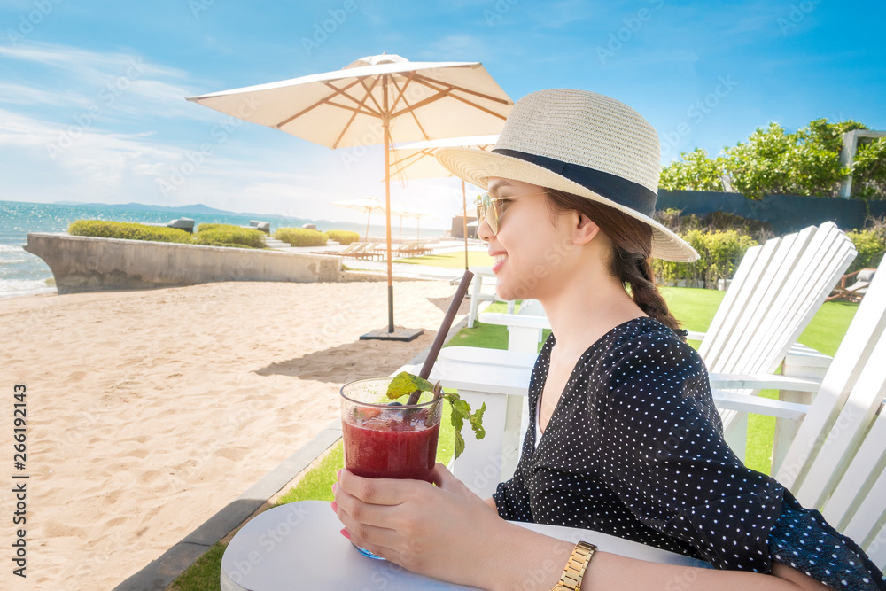 Beautiful woman is relaxing on the beach , under umbrella Stock Photo ...