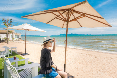 Beautiful woman is relaxing on the beach , under umbrella © tonefotografia