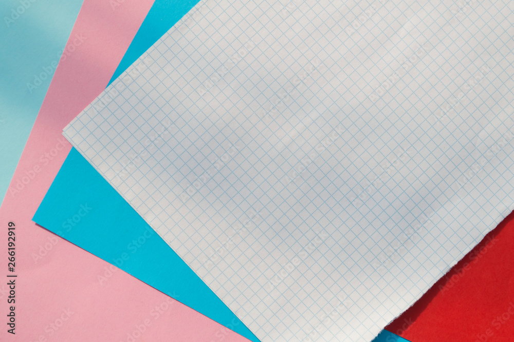 Sheets of colored paper and a sheet of white checkered paper. Sheets of colored paper and a sheet of white checkered paper.