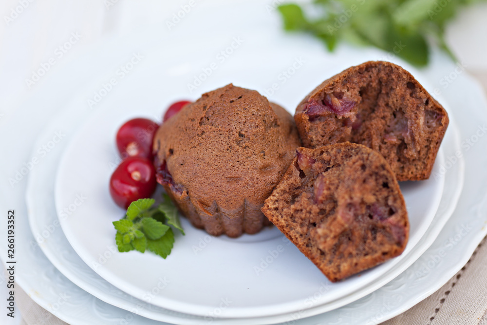 Chocolate muffins with ripe cherries