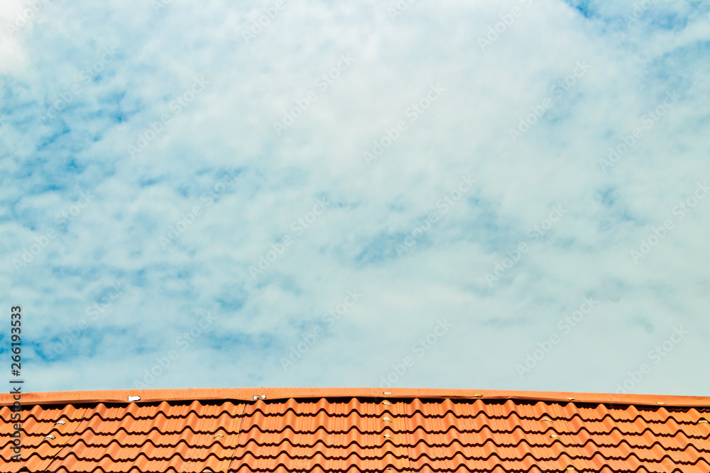 Red roof with a cloudy blue sky on top Red roof with a cloudy blue sky on top