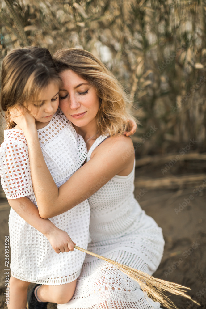 Fototapeta premium mother and daughter hugging in nature at summer