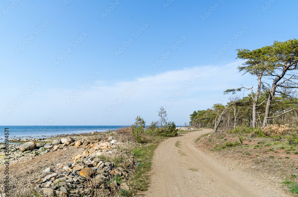 Beautiful winding gravel road by the coast