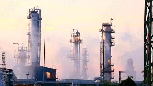 The vapor of the mist that is distilled from the cooling water to the factory with the oil refinery on morning time photo