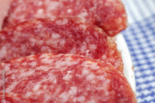 Slices of red smoked sausage close up with coopy space photo