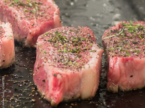 Closeup of steaks cooking.