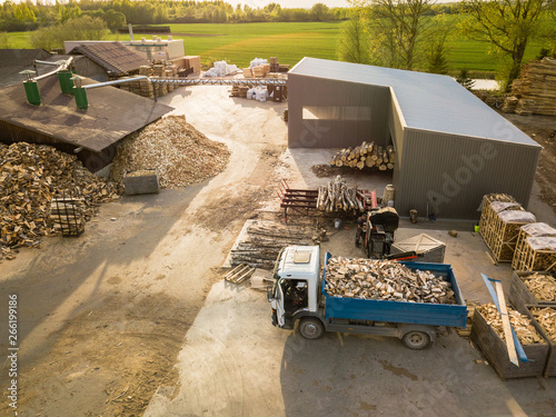 Aerial view of sawmill site with firewood being loaded to truck